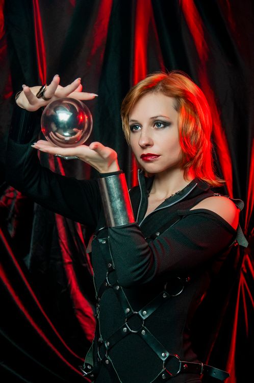 Female In Halloween Costume Looking At Shiny Ball In Red Light Free female-in-halloween-costume-looking-at-shiny-ball-in-red-light-free