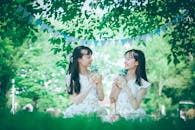 Photograph of Sisters Holding Glass Jars