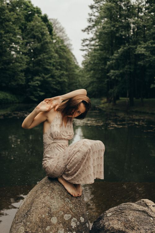 A Woman Sitting on Rock · Free Stock Photo