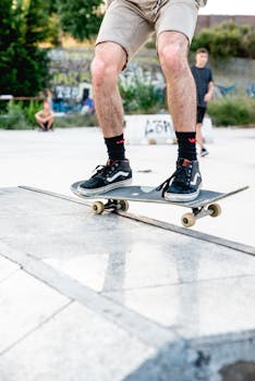 Skateboarder performing a trick on a concrete ramp at an outdoor urban skatepark.