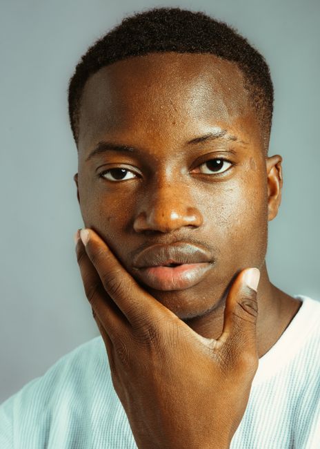 Portrait of a young man with a thoughtful expression against a neutral background.