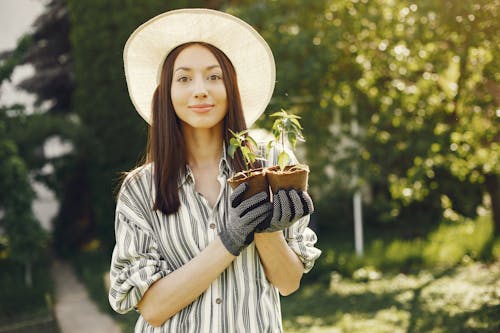 Woman Holding Potted Plants