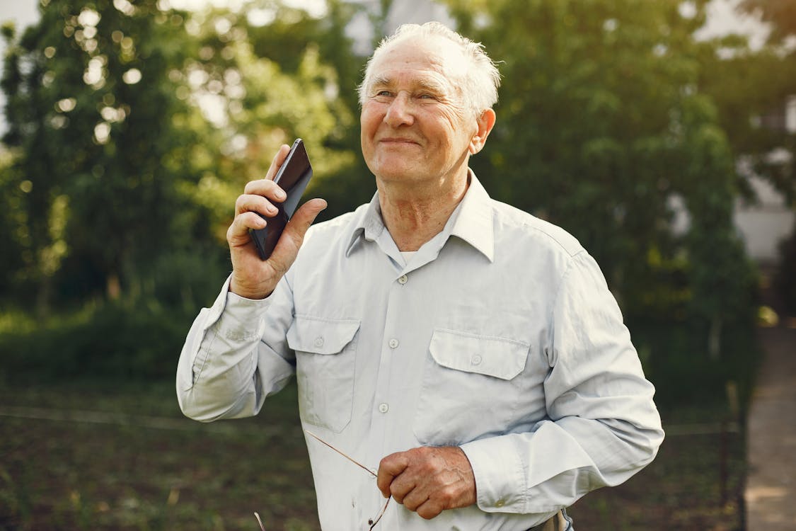 Smiling Elderly Man Holding a Cellphone