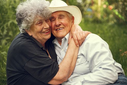 Free A joyful elderly couple hugging outdoors, exhibiting warmth and affection. Stock Photo