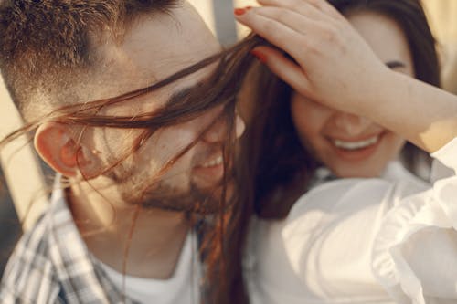 Free Photo of a Woman's Hair Covering a Man's Eyes Stock Photo