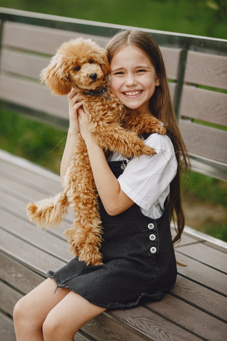 Portrait Of Happy Teen Girl Posing With Dog