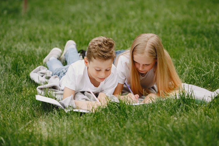 Happy Children Lying On Grass Drawing