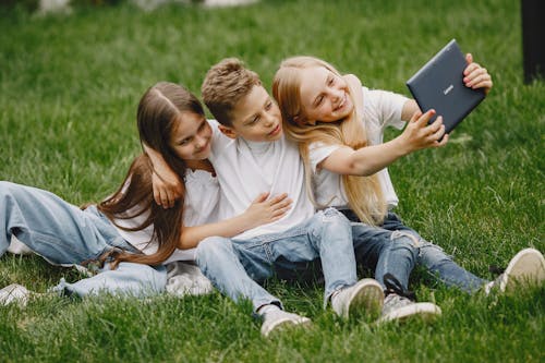 Children with Tablet on Grass