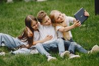 Children with Tablet on Grass