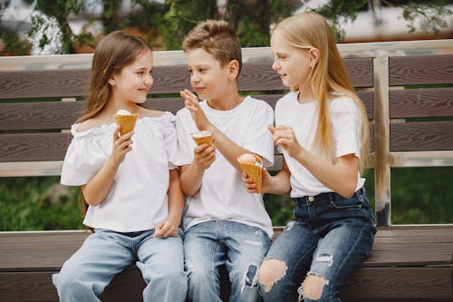 Free Kids Reading Eating Ice Cream Together Stock Photo