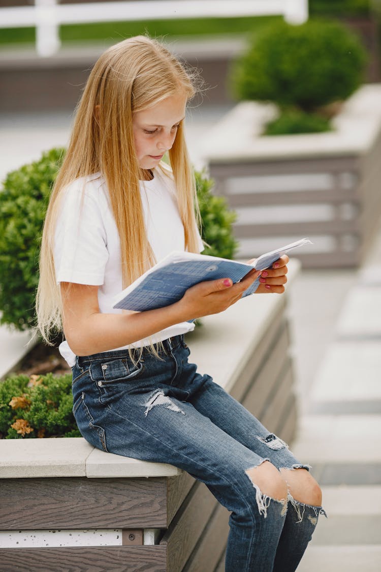 Teenager Reading Textbook Outside