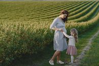 Woman in White Dress Standing on Green Grass Field
