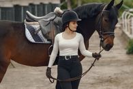 Woman in White Long Sleeve Shirt and Black Skirt Riding Brown Horse