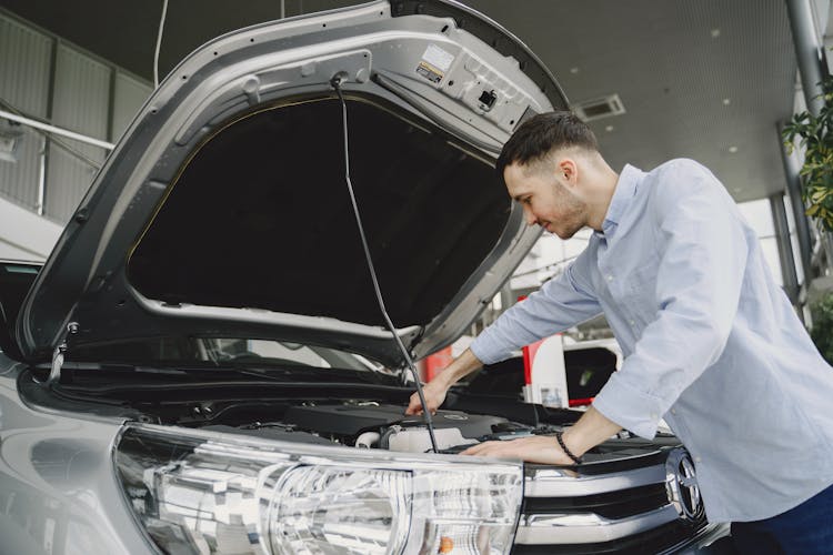 Man Checking The Engine Of A Car