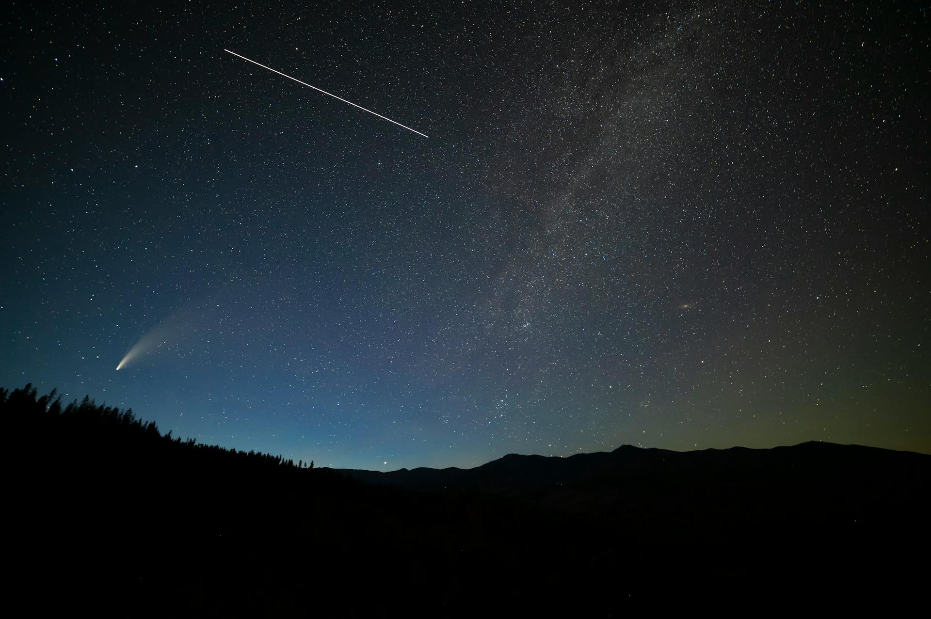 Breathtaking view of a starry sky with comet and shooting star over Entiat, WA.