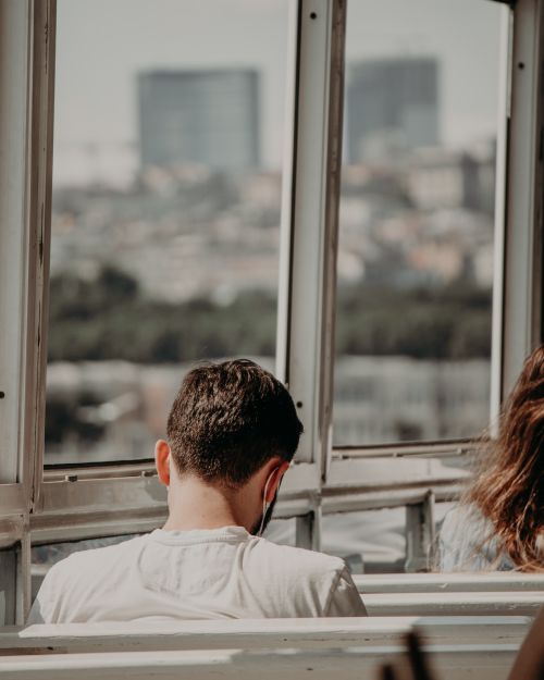 Free Person sitting on ferry with city view through windows in Istanbul, Türkiye. Stock Photo