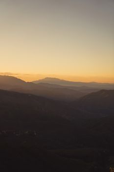Peaceful twilight view of Big Bear Mountains with stunning sunset hues and layered peaks.