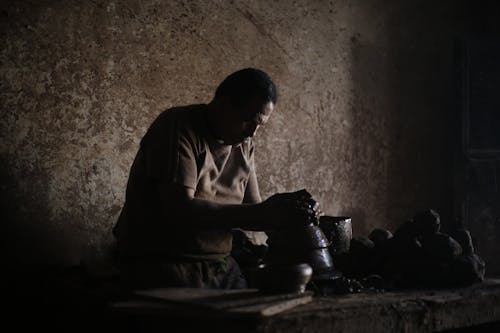 An Artisan Making Clay Pottery