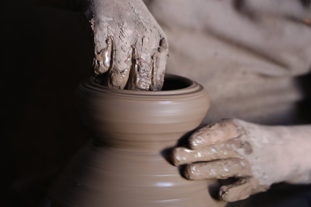 Artisan shaping clay pottery in Colorado Springs studio