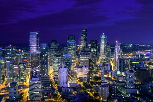 Free A vibrant aerial view of Seattle's illuminated skyline at night featuring iconic skyscrapers. Stock Photo