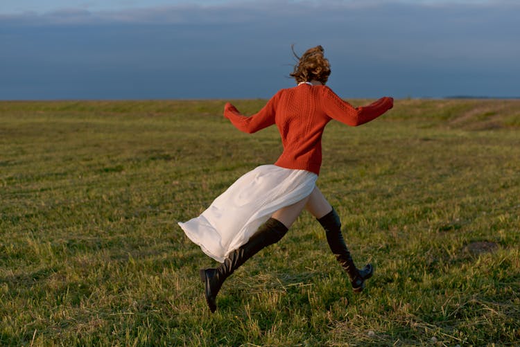 A Woman Running On The Field