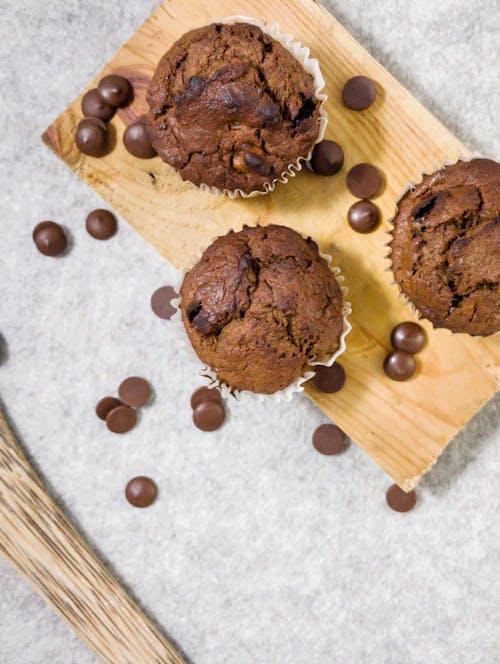 Chocolate Muffins and Chocolate Chips on a Wooden Board