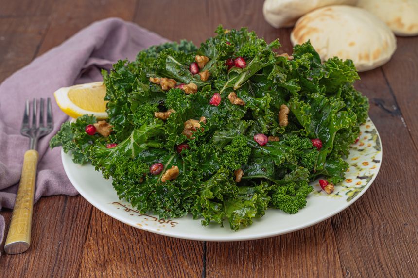 Kale salad with pomegranate and walnuts — photo by Denys Gromov on Pexels