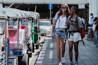 2 Women Standing on Sidewalk