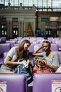 Woman in Gray Shirt Sitting on Purple Chair