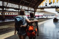 Woman in Black and White Shirt and Red Leather Backpack Carrying Black and Brown Leather Shoulder