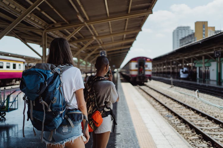 Backpackers On Railway Station