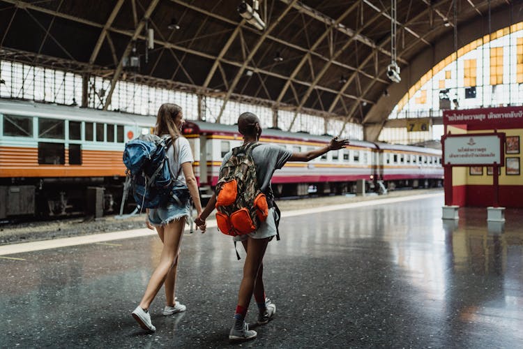 Two Women Walking At The Train Station