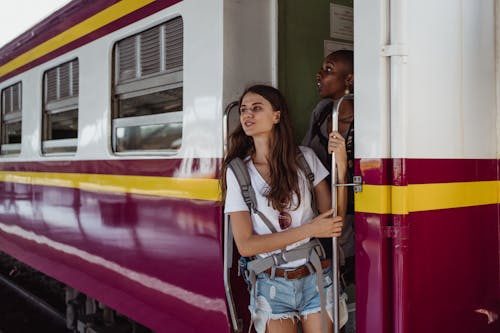 Women Looking Out Through Door of Train Car