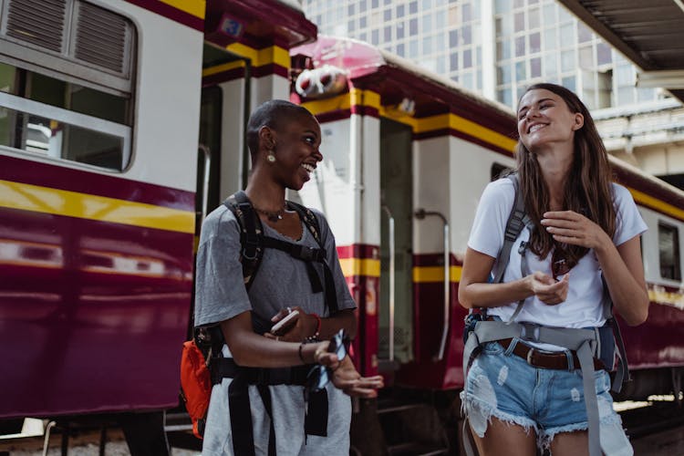 Women Standing On Train Platform Laughing