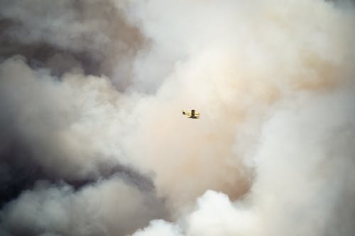 Airplane in Mid Air Under White Clouds