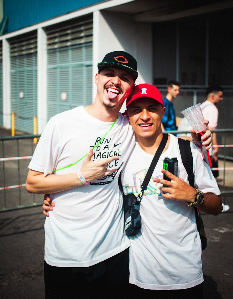 Two Happy Men In Baseball Caps Posing For A Picture