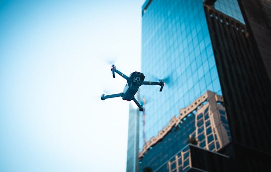 High-tech drone operating near a modern skyscraper captures urban technology in action.