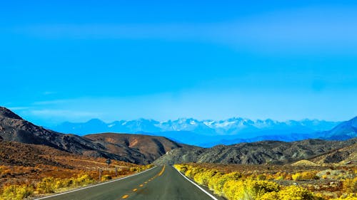 Free Road Heading Towards Mountain Stock Photo