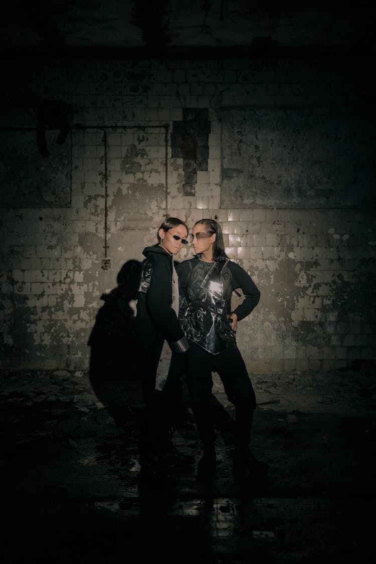 Man And Woman Standing Beside Brick Wall