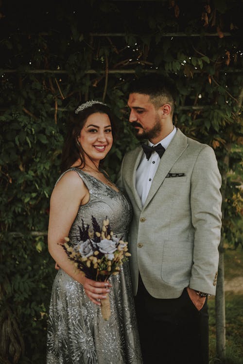 Elegant newlyweds in wedding clothes during wedding celebration