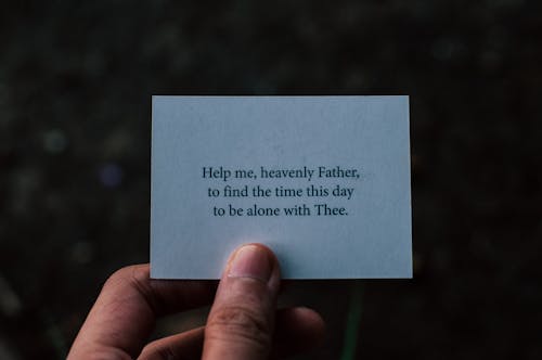 Close-up of Person Holding a Card with Text of a Prayer 