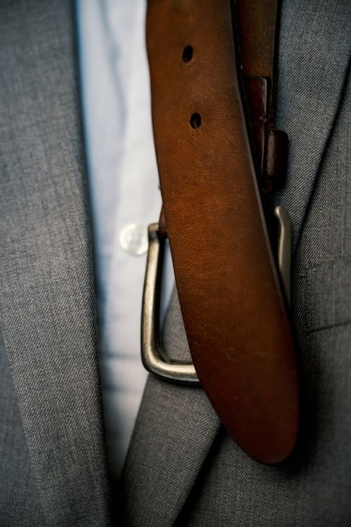 Free Classic male suit with gray jacket and white shirt near leather belt with metal buckle Stock Photo