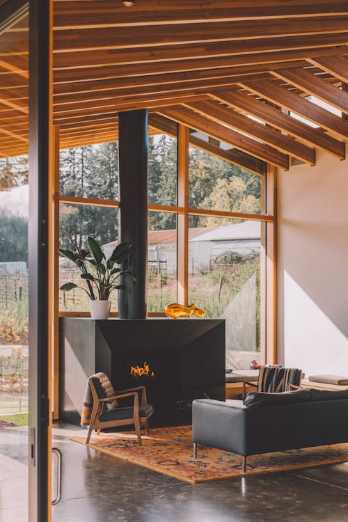 A Living Room with Glass Walls Overlooking a Picturesque Neighborhood
