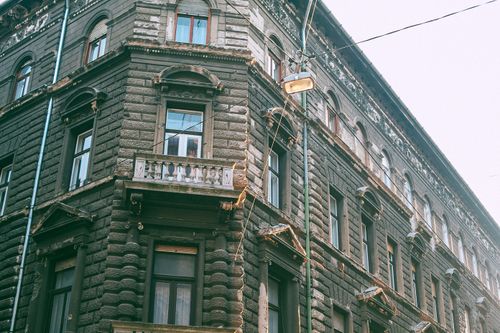 Free From below of exterior of classic dwell apartment house with ornamental windows and small balcony in town Stock Photo