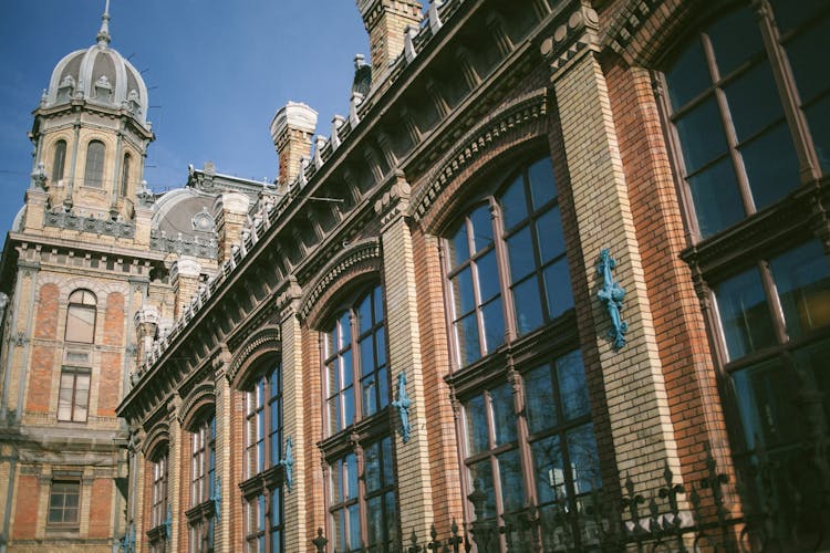 Ornamental Facade Of Brick Building With High Dome Construction Behind