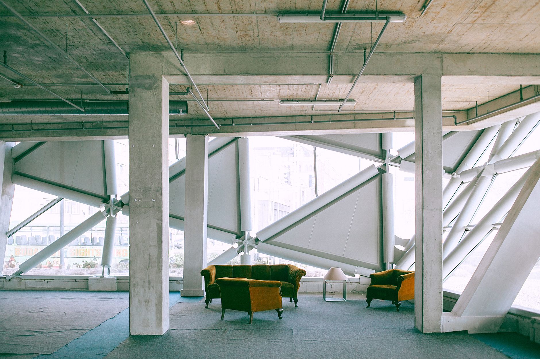 Interior design of spacious lounge zone with yellow sofas in industrial building in daylight
