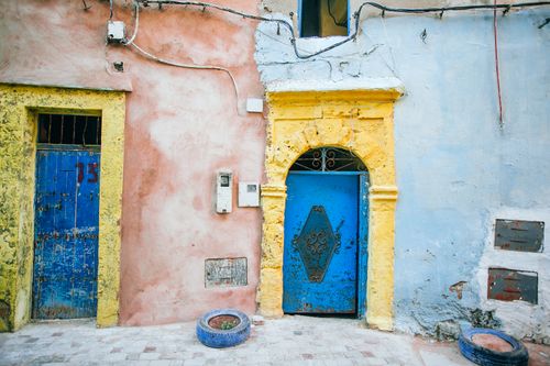 Free Exterior of aged house with cement walls and threadbare doors on pavement street Stock Photo