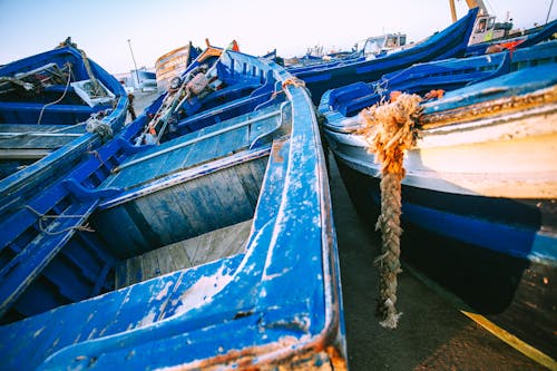 Shabby boats on coast of sea