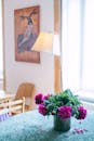 Vase with flowers on table in room