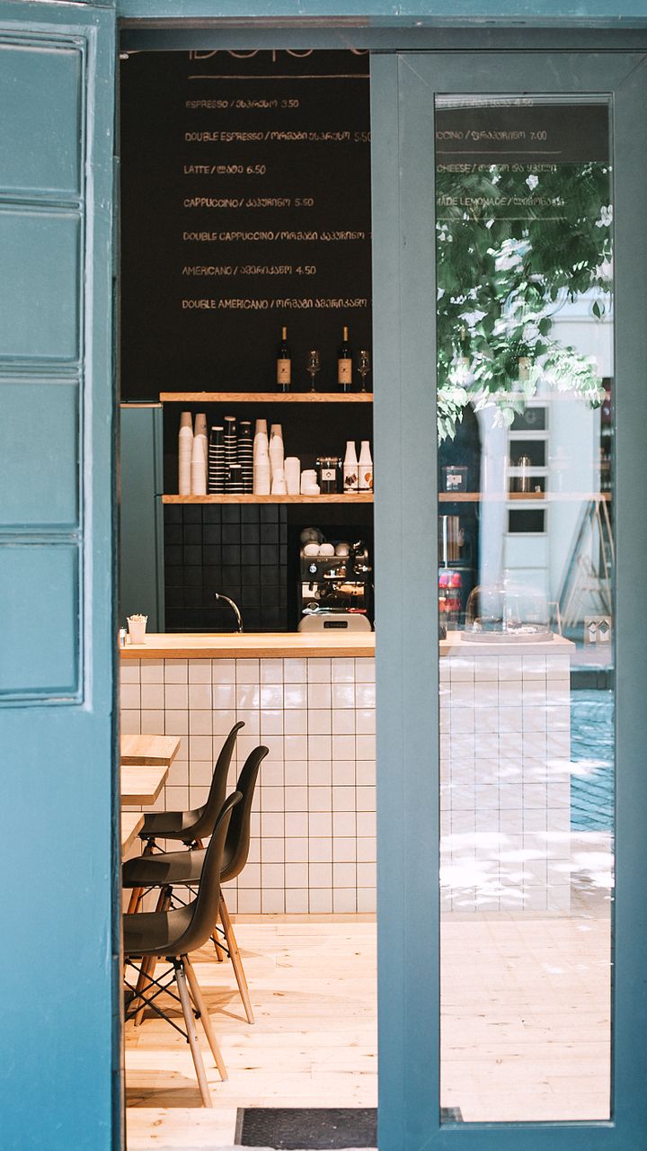sleek open armoire converted to a minimalist coffee station with hidden storage